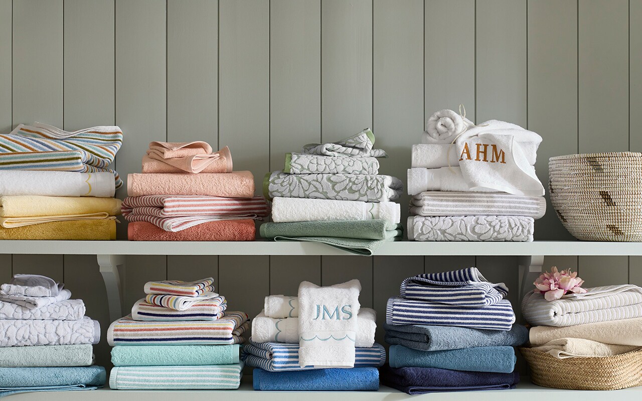 Shelves of bath towels in various patterns and colors. Shop towels.
