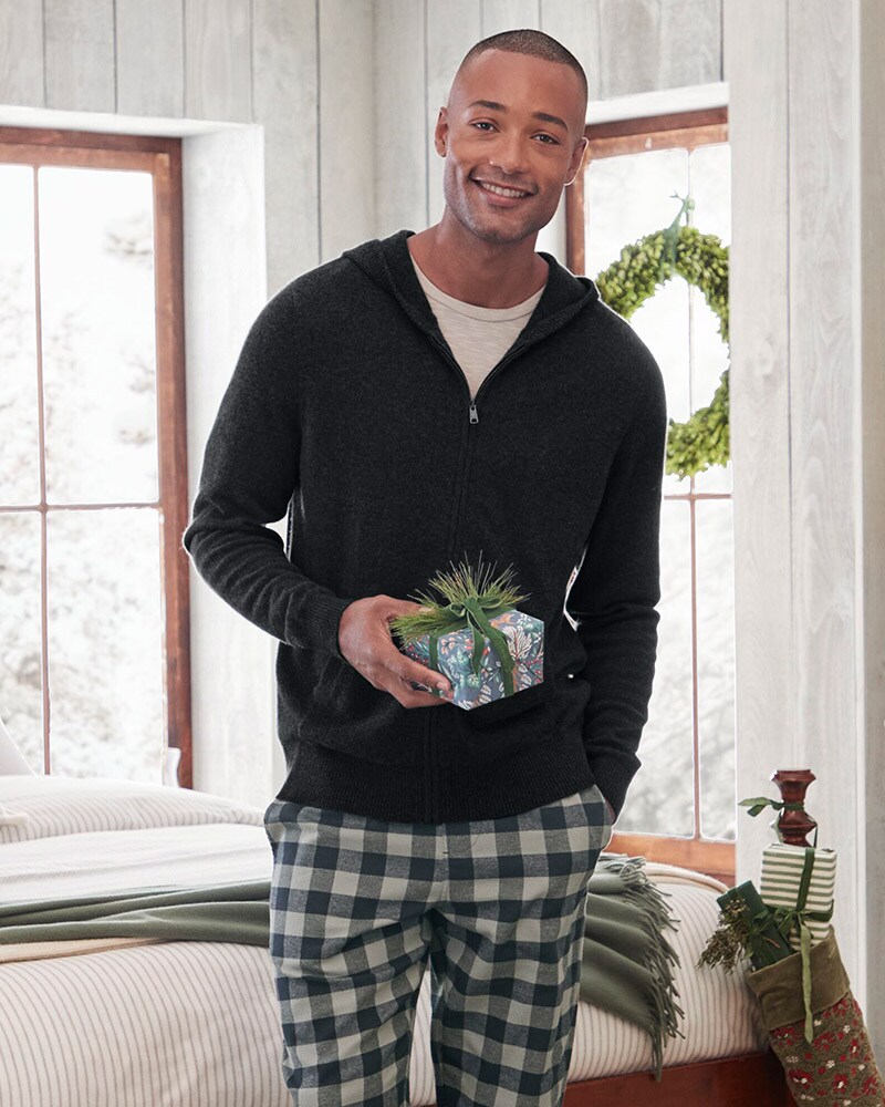 A man wearing a navy blue button-front sweatshirt. Browse the Men's Shop.