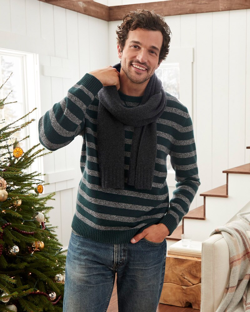 A man in a blue and gray striped cashmere sweatshirt with a cashmere scarf. Visit the Men's Shop.